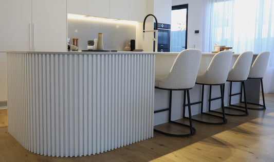 Stylish white bar stools in a row