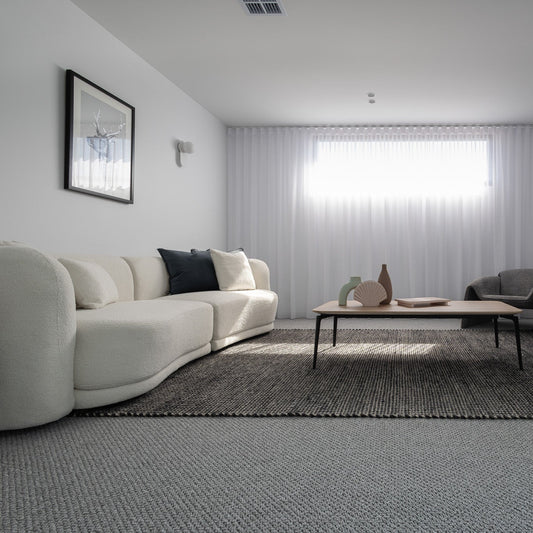 Modern four seater fabric sectional sofa with clean, straight cushions.