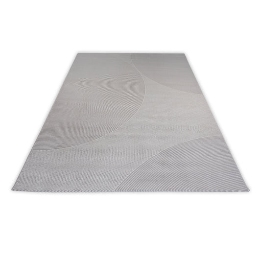 Rectangular grey rug with circular patterns on a light grey background