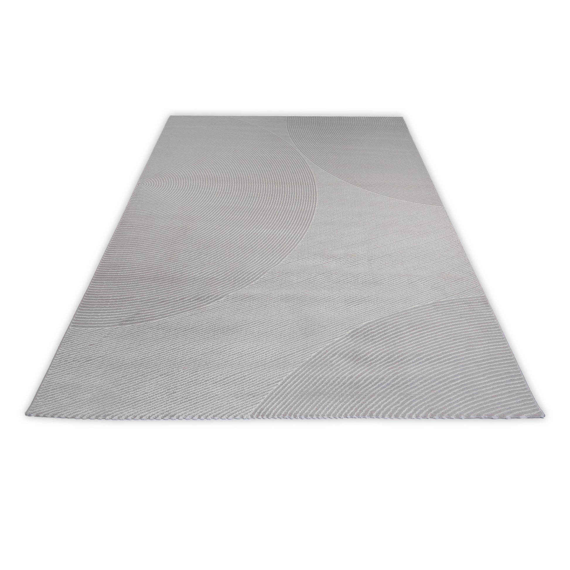 Rectangular grey rug with circular patterns on a light grey background