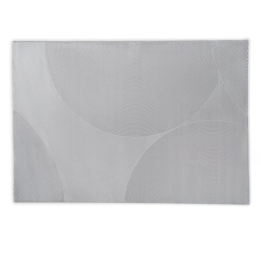 Rectangular grey rug with circular patterns on a light grey background
