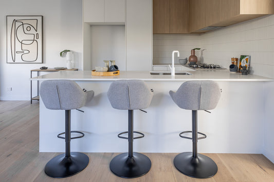 Bar stools beside a white marble counter