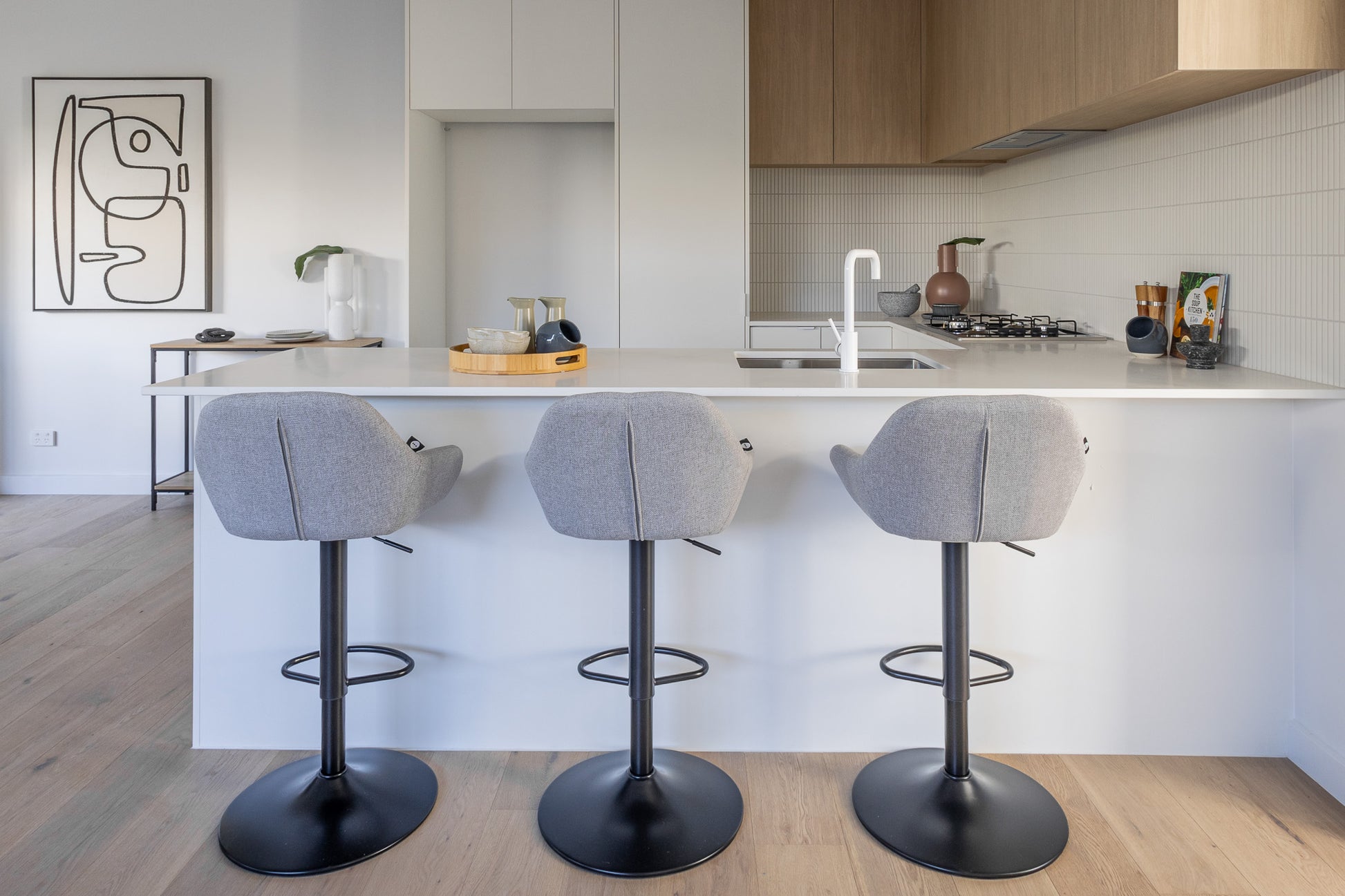 Bar stools beside a white marble counter